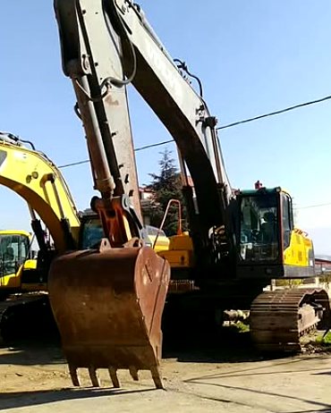 Volvo tracked excavator with bucket lowered in the Sultan equipment yard